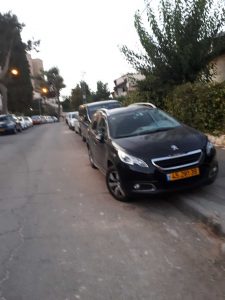 Israeli cars perched on the sidewalk for their night's sleep