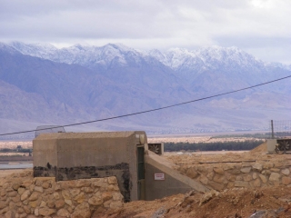 Kibbutz bunker against snowy Edom mountains, Arava 2013