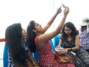 Students taking selfies on boat to Elephanta Island