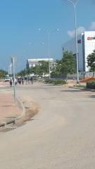 Group hiking in midday heat through Industrial Park Emek Hefer, Sharon, Israel Group hiking in midday heat through Industrial Park Emek Hefer, Sharon, Israel