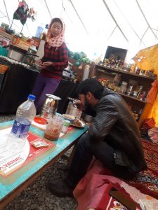 Ladakhi woman serving food to our driver at outpost