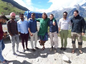 Our group and other travelers posing against snowy peaks on road from Manali to Leh Our group and other travelers posing against snowy peaks on road from Manali to Leh