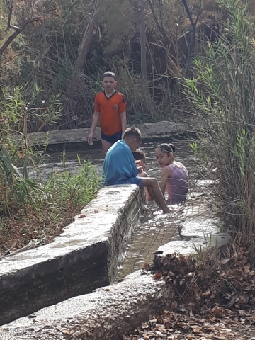 Arab children enjoying the cool water of the canal. Einot Tzukim Arab children enjoying the cool water of the canal. Einot Tzukim