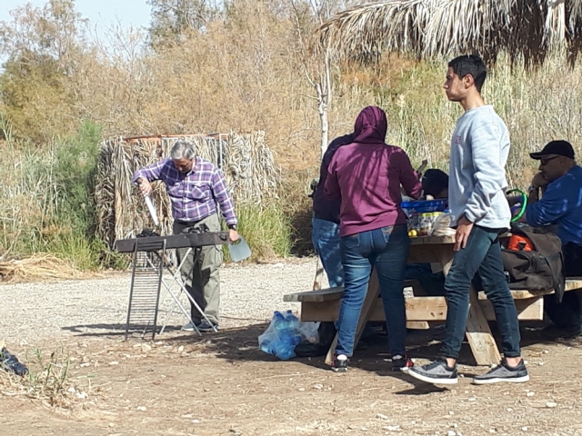 Fanning the meat. arabs having a mangal at Einot Tzukim Nature Reserve Fanning the meat. arabs having a mangal at Einot Tzukim Nature Reserve