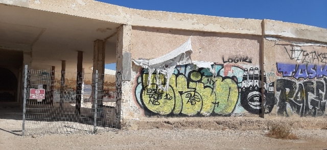 Graffity on abandoned British military base. Security road past Lido Graffity on abandoned British military base. Security road past Lido